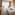 Luxury hotel room with king bed, flat-screen TV, wooden desk, and bright window.