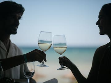 a man and woman holding wine glasses