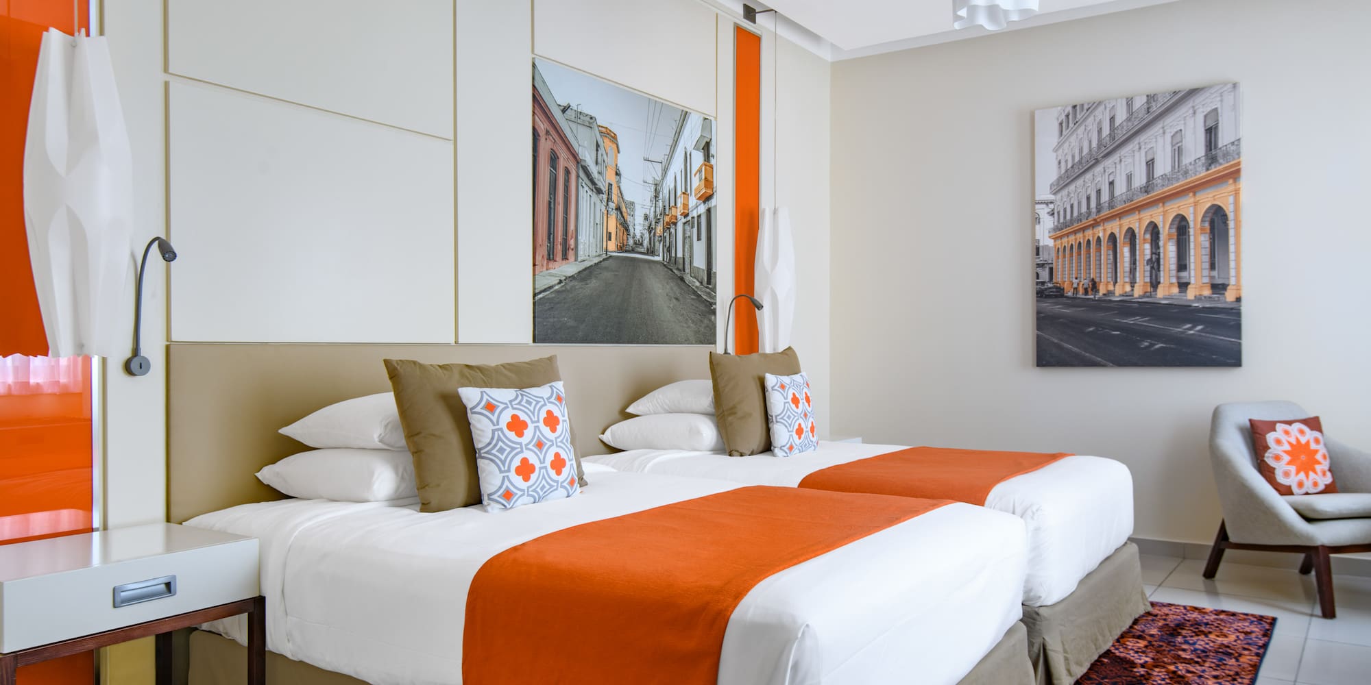 a bed with orange and white pillows