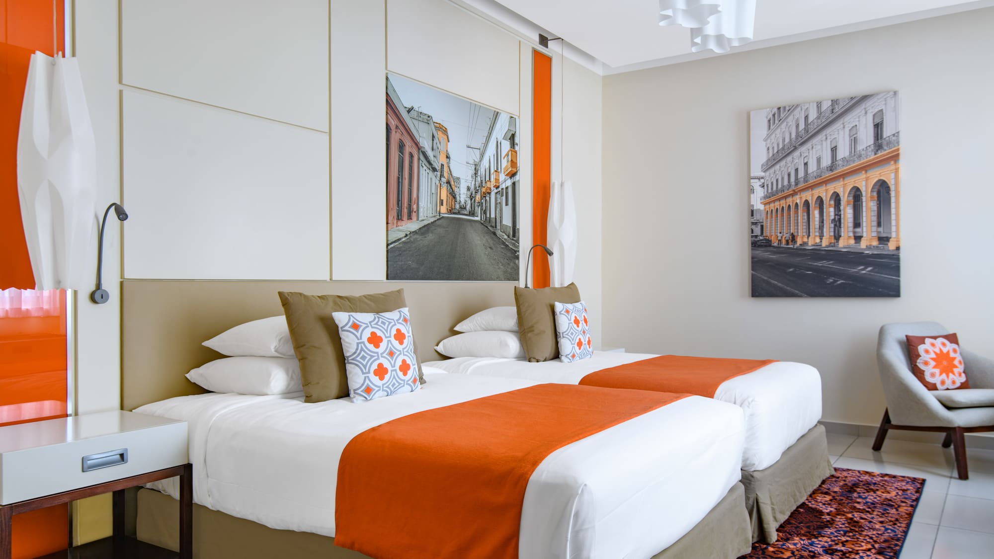 a bed with orange and white pillows