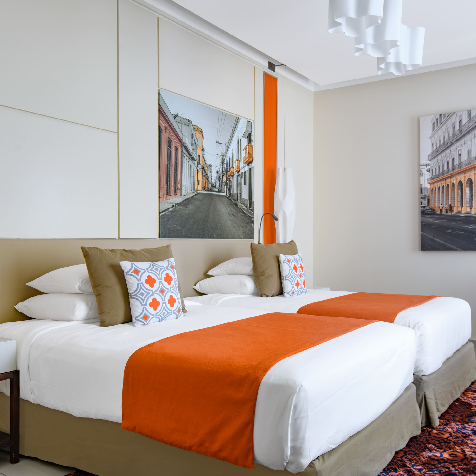 a bed with orange and white pillows