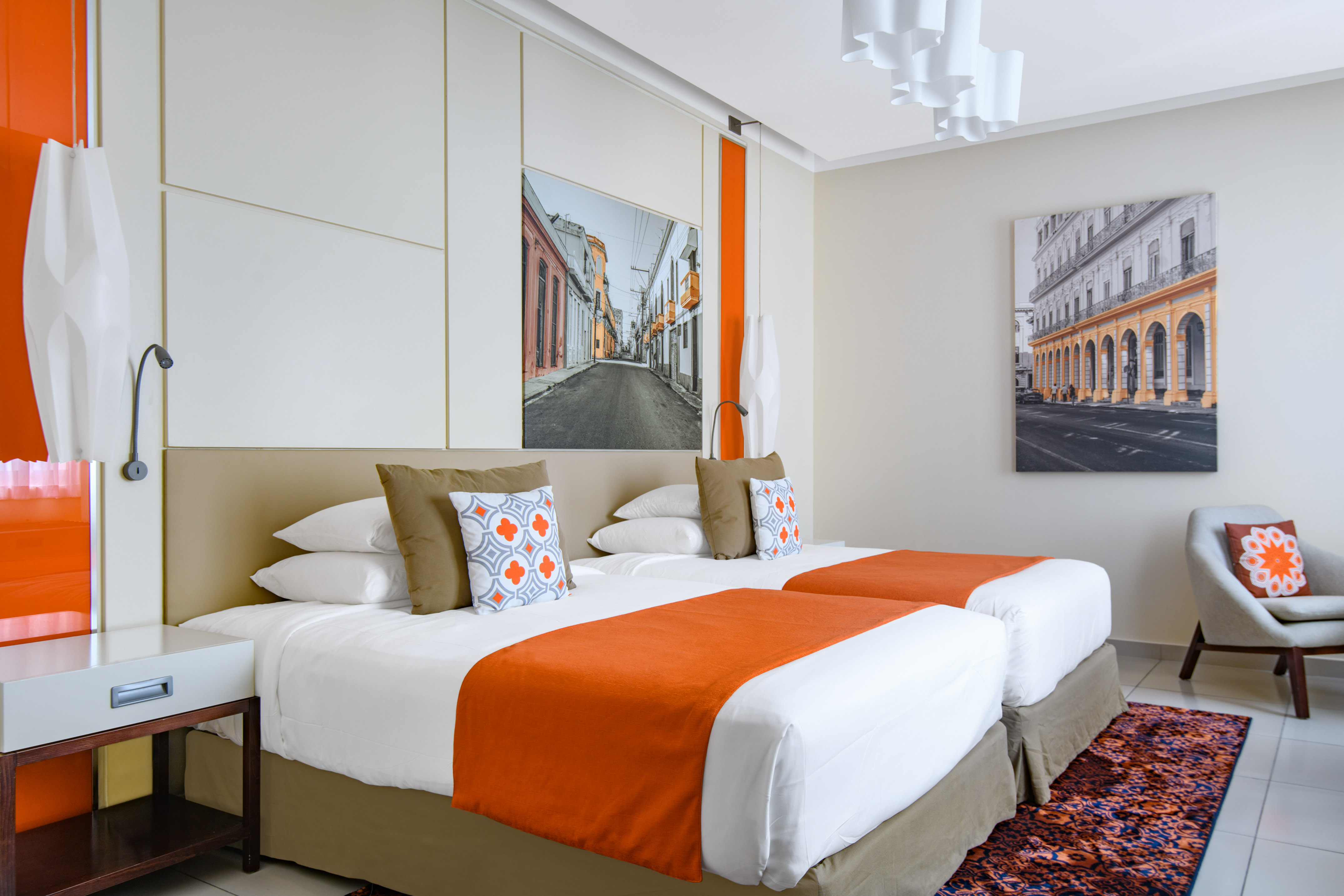 a bed with orange and white pillows