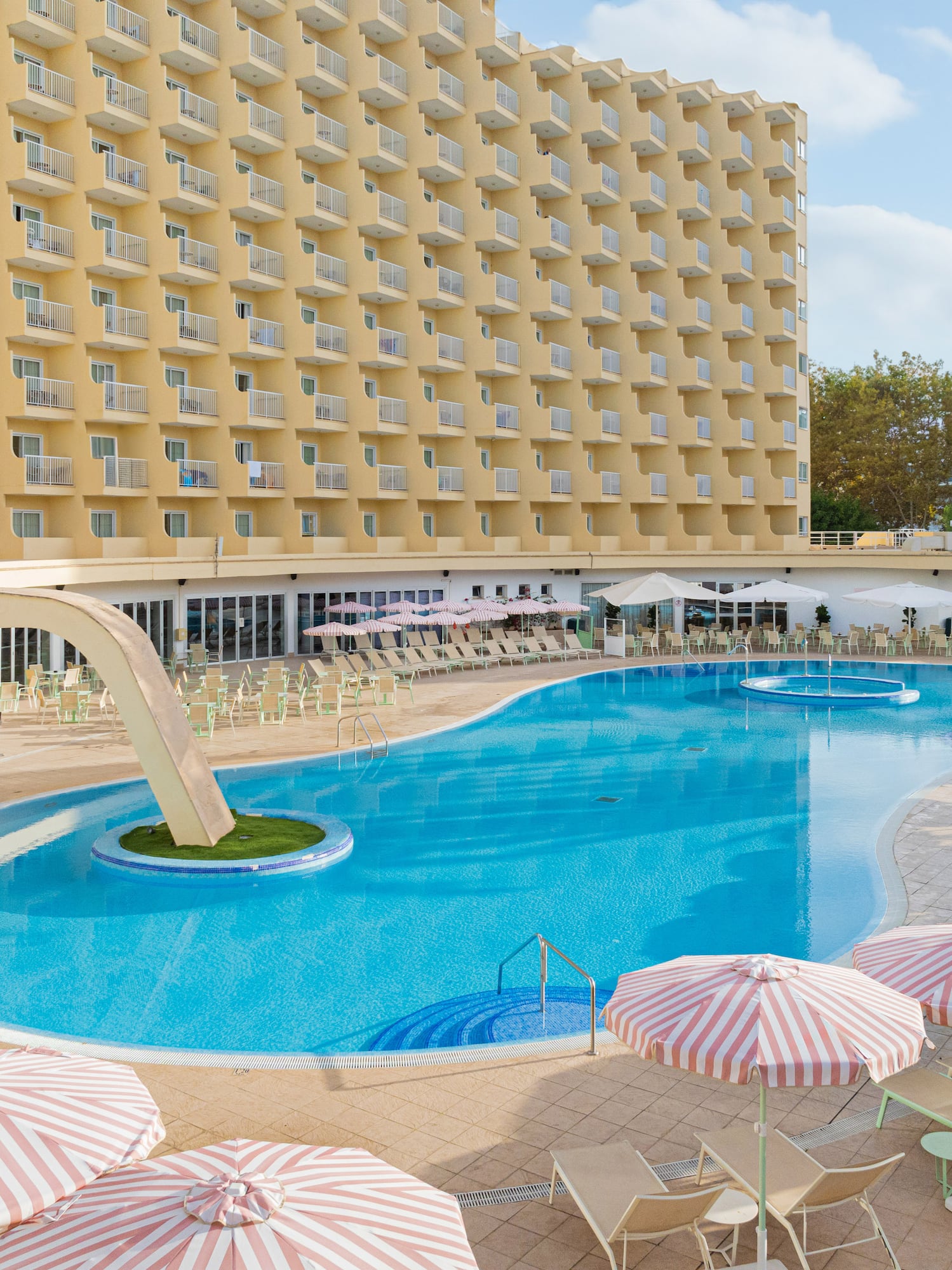 a swimming pool with umbrellas and chairs