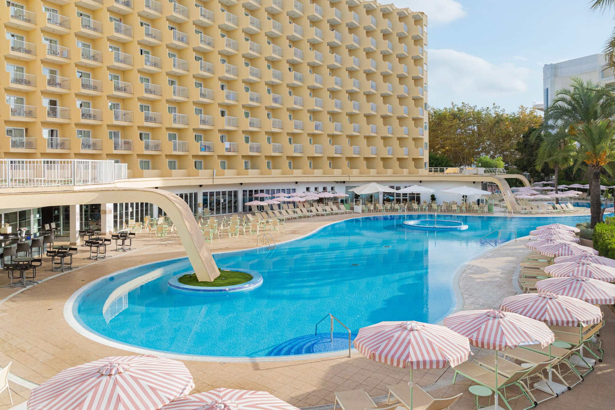 a swimming pool with umbrellas and chairs