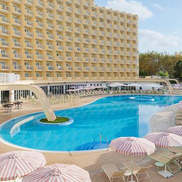 a swimming pool with umbrellas and chairs