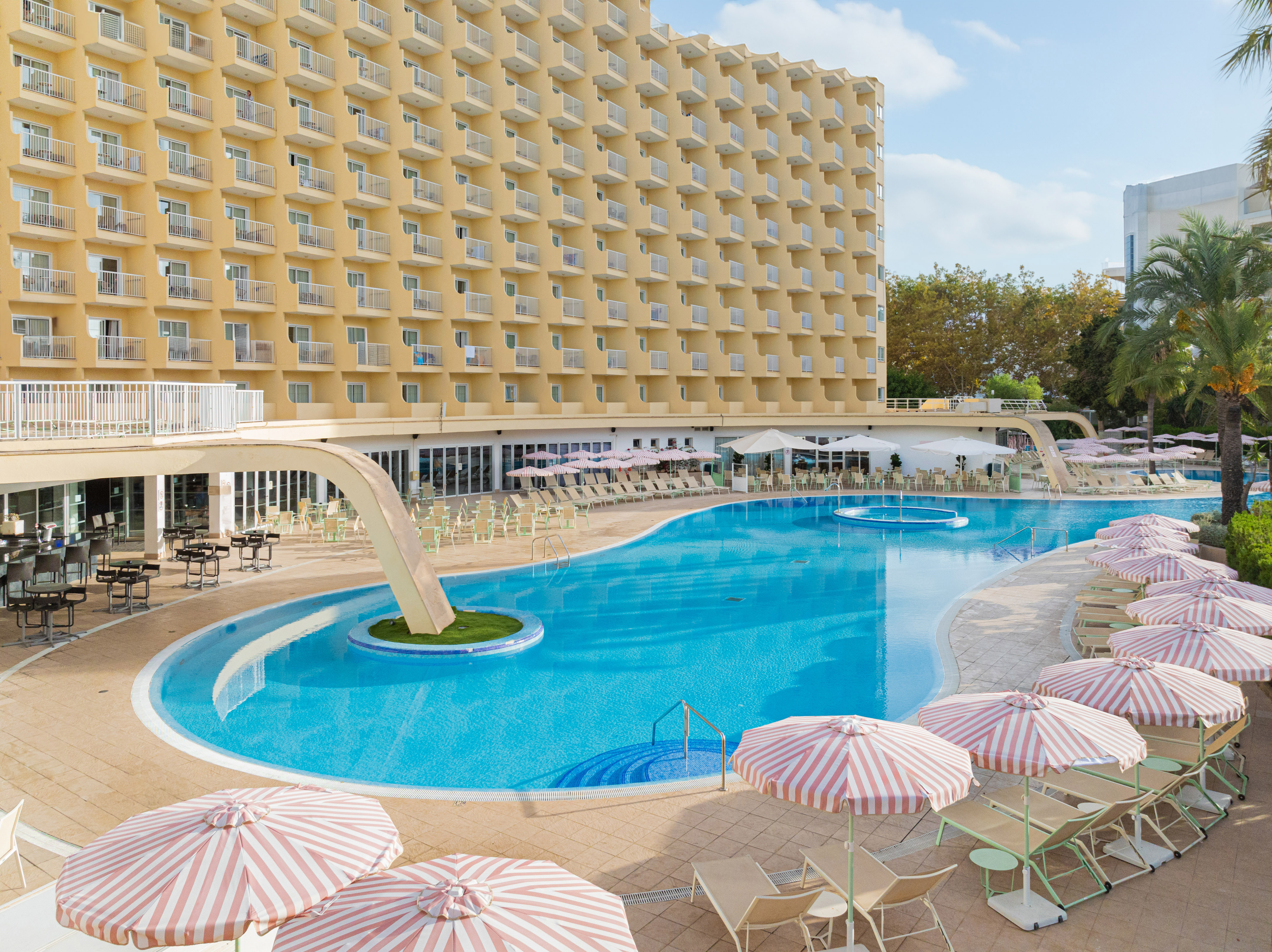 a swimming pool with umbrellas and chairs
