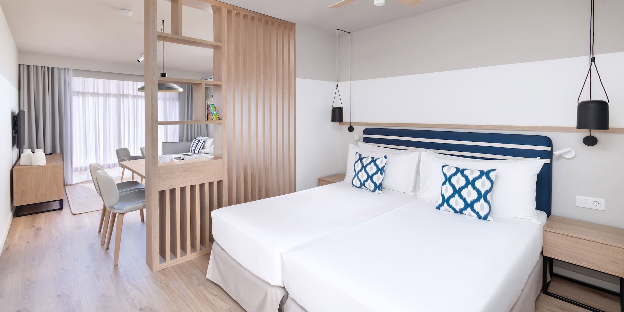 a room with two beds and a wood wall