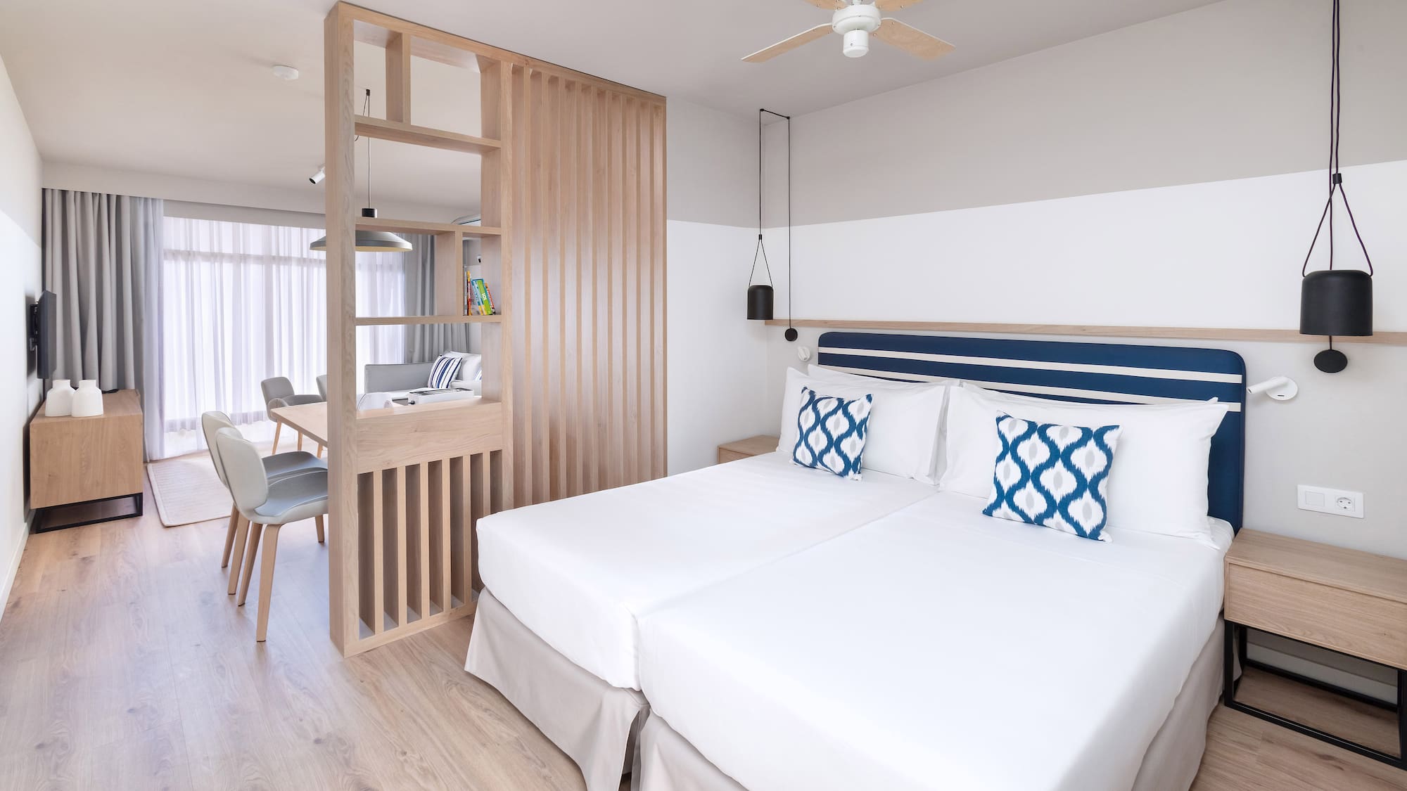 a room with two beds and a wood wall