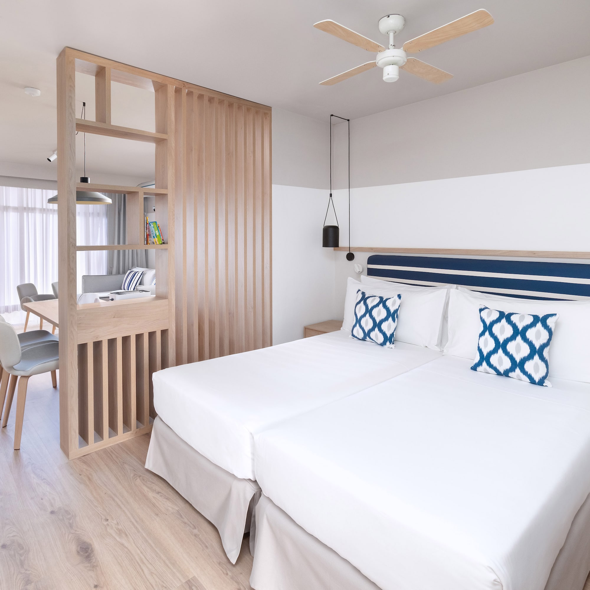 a room with two beds and a wood wall