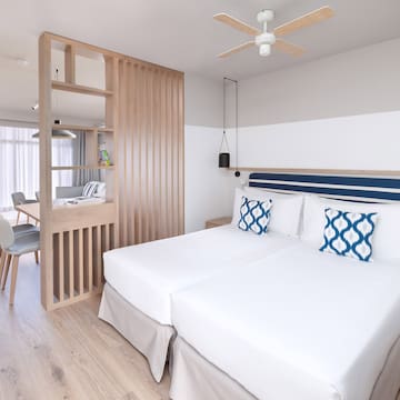 a room with two beds and a wood wall