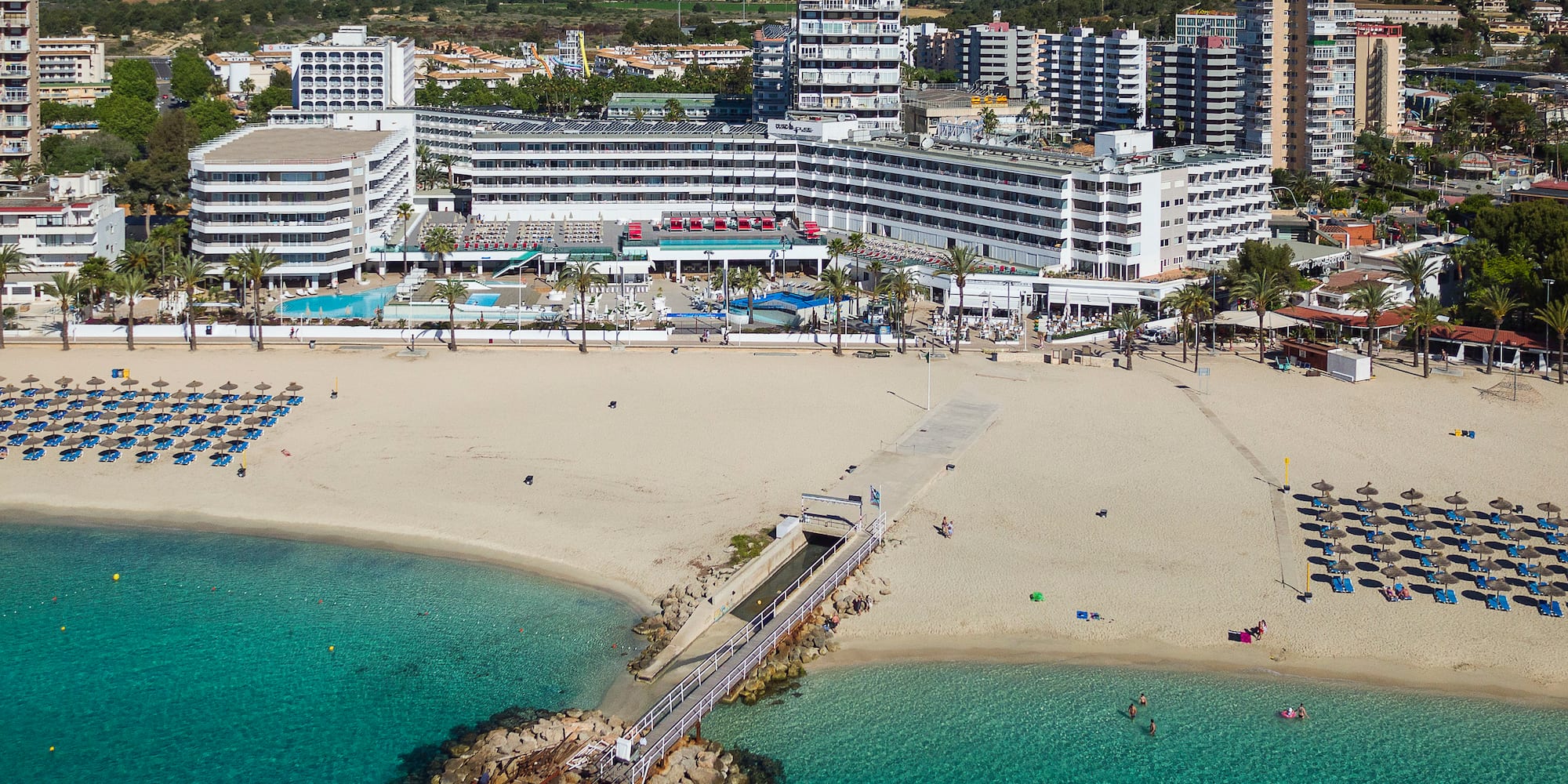 a beach with a body of water and buildings
