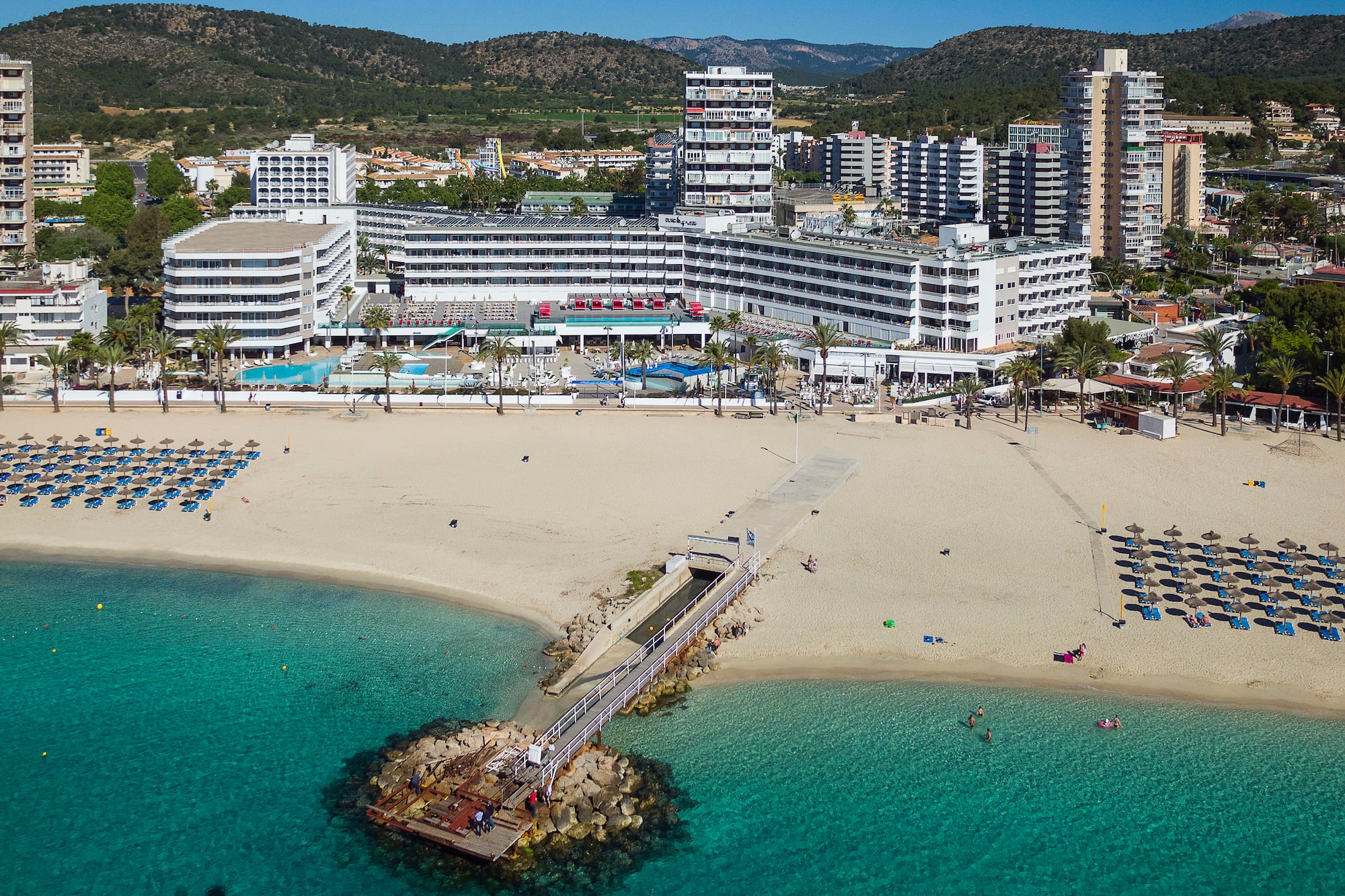 a beach with a body of water and buildings