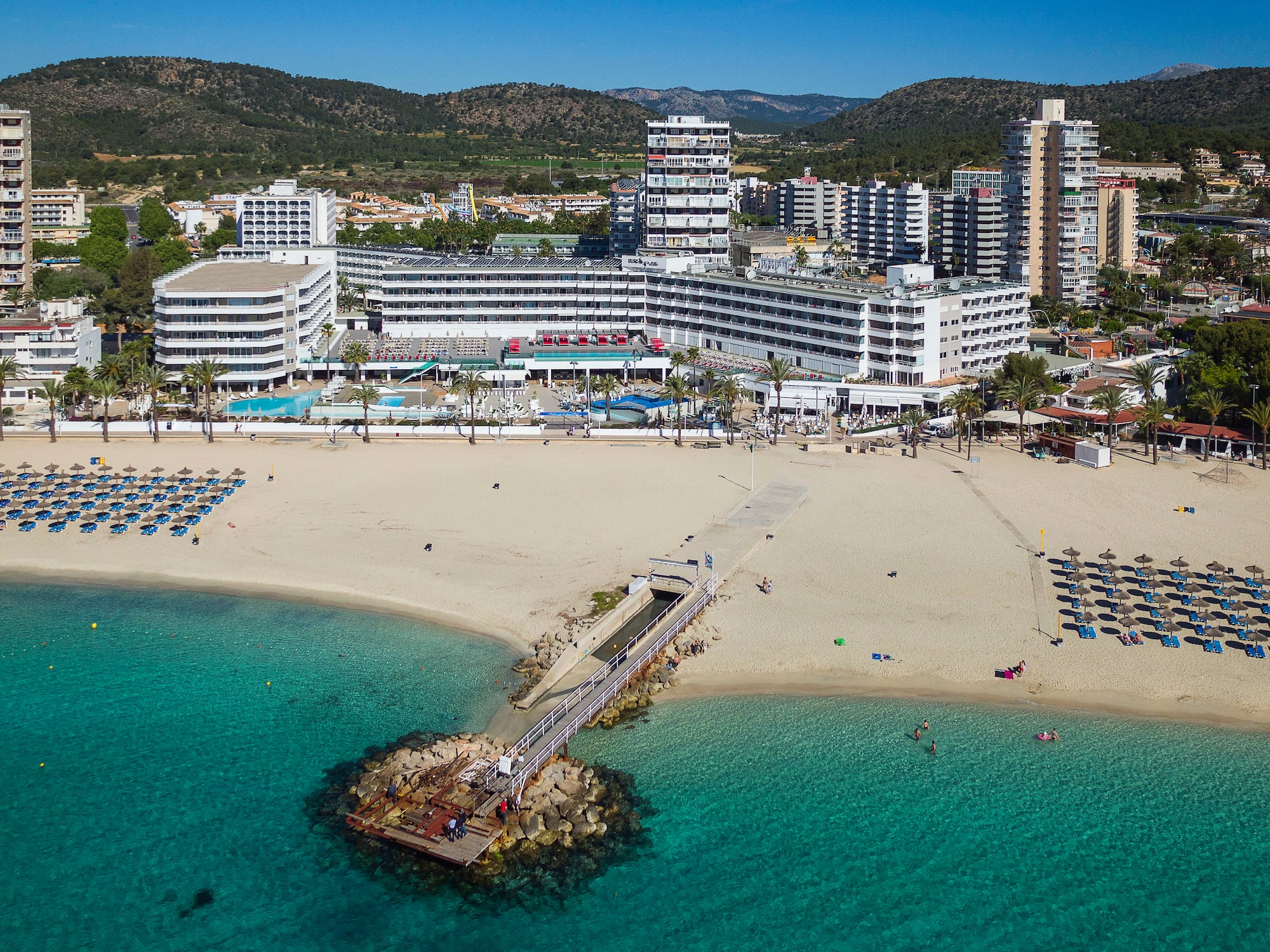 a beach with a body of water and buildings