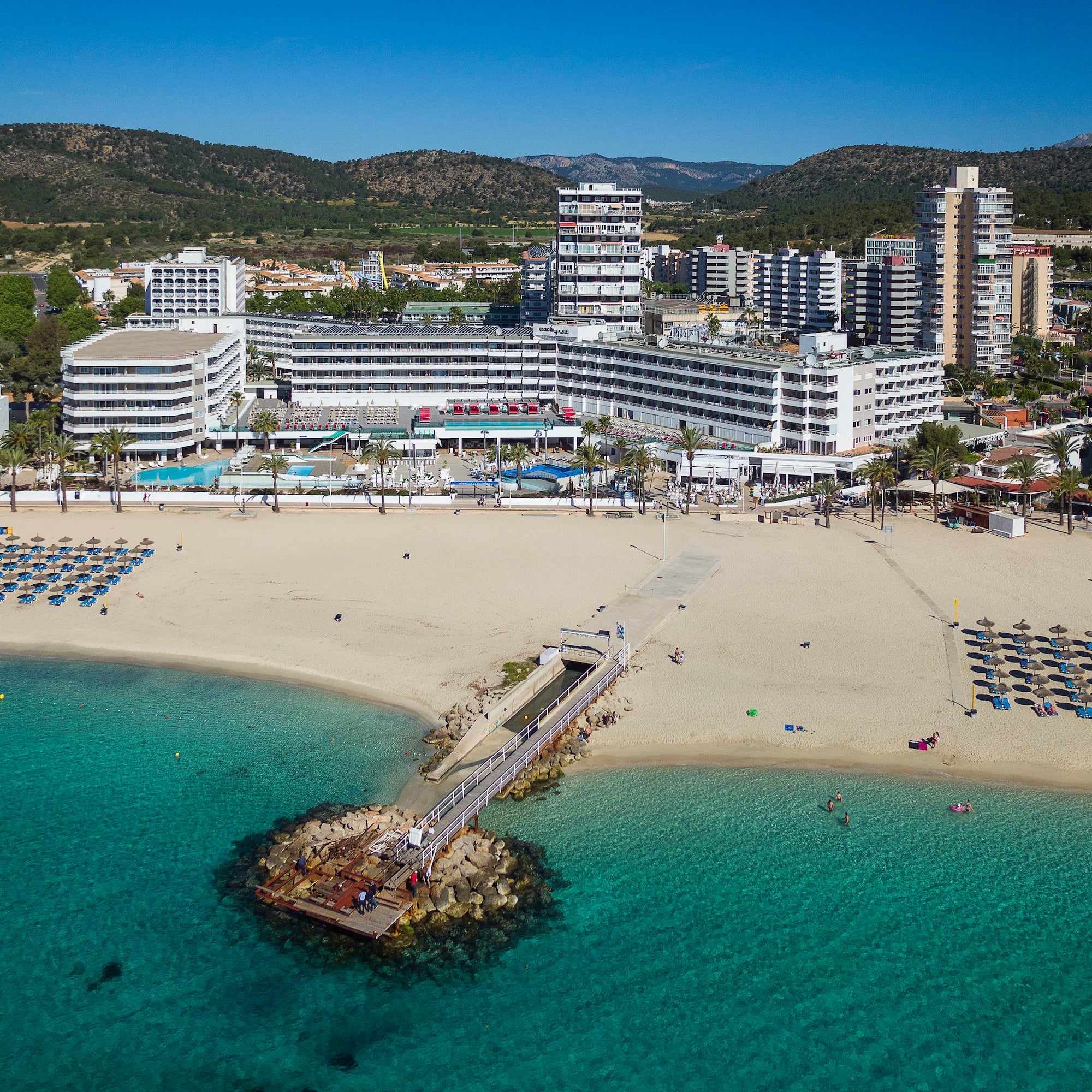 a beach with a body of water and buildings