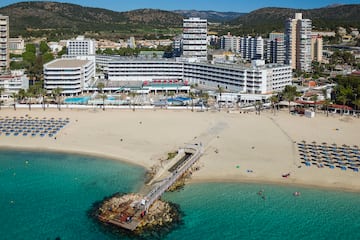 a beach with a body of water and buildings