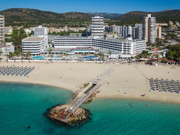 a beach with a body of water and buildings