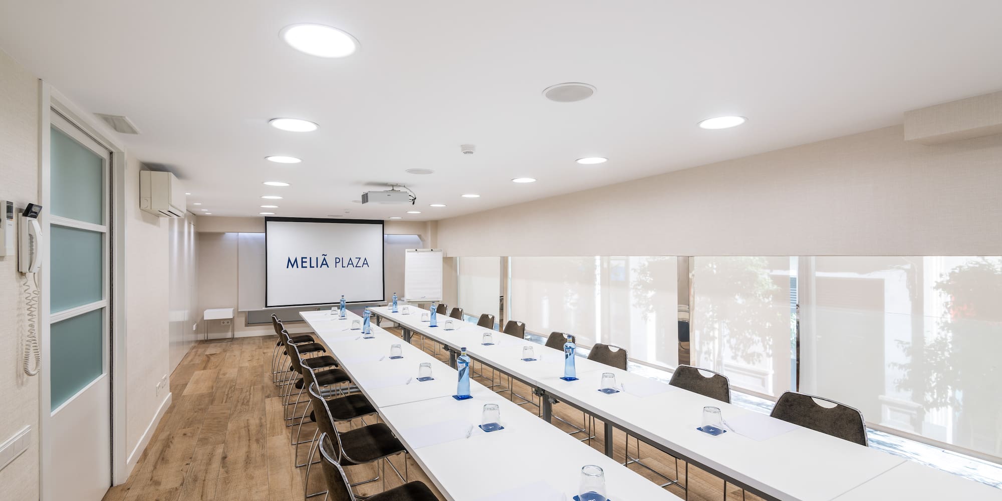 a room with long tables and chairs