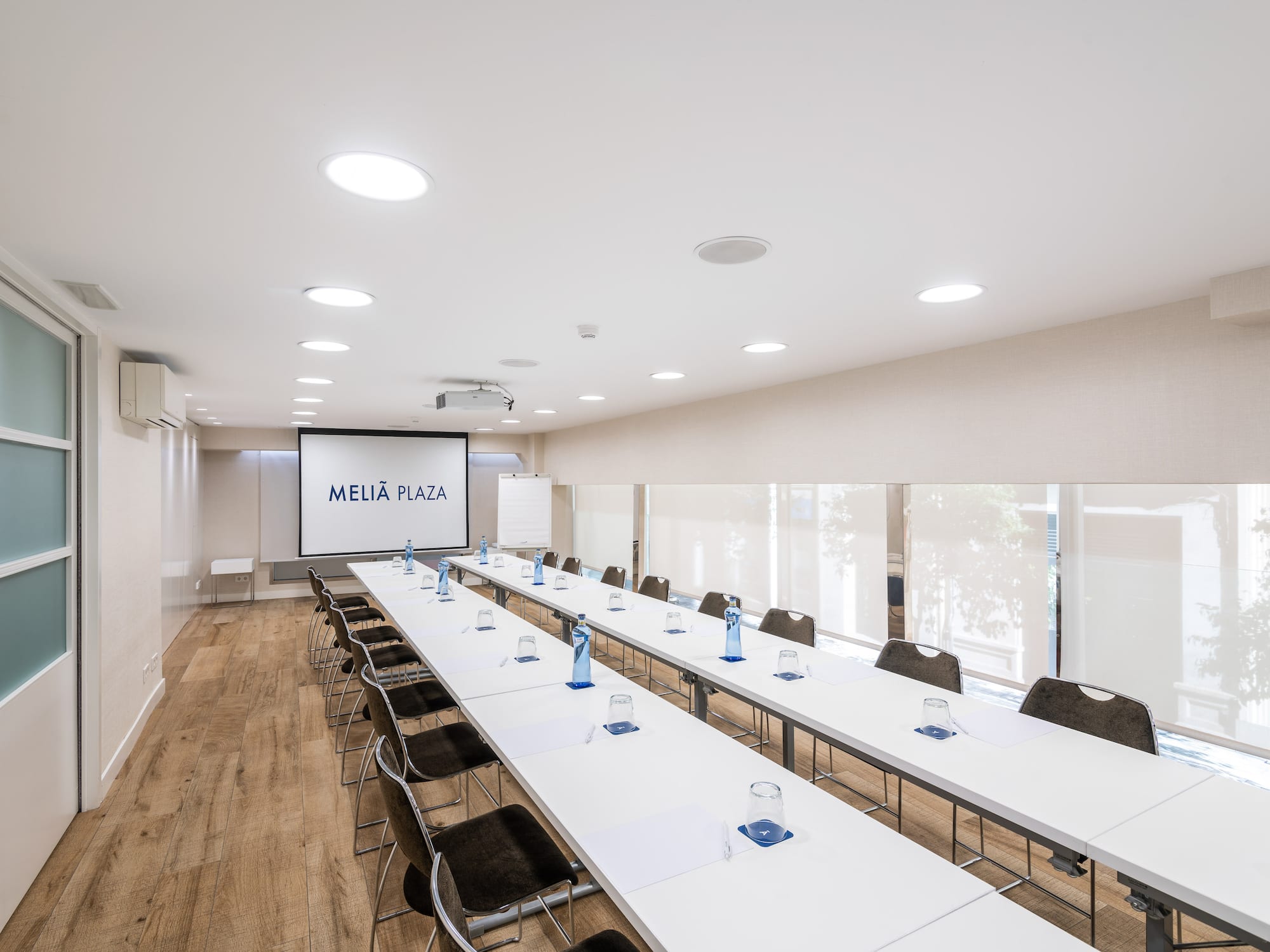a room with long tables and chairs
