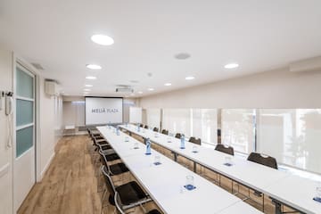 a room with long tables and chairs