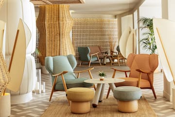 a room with wicker furniture and a table