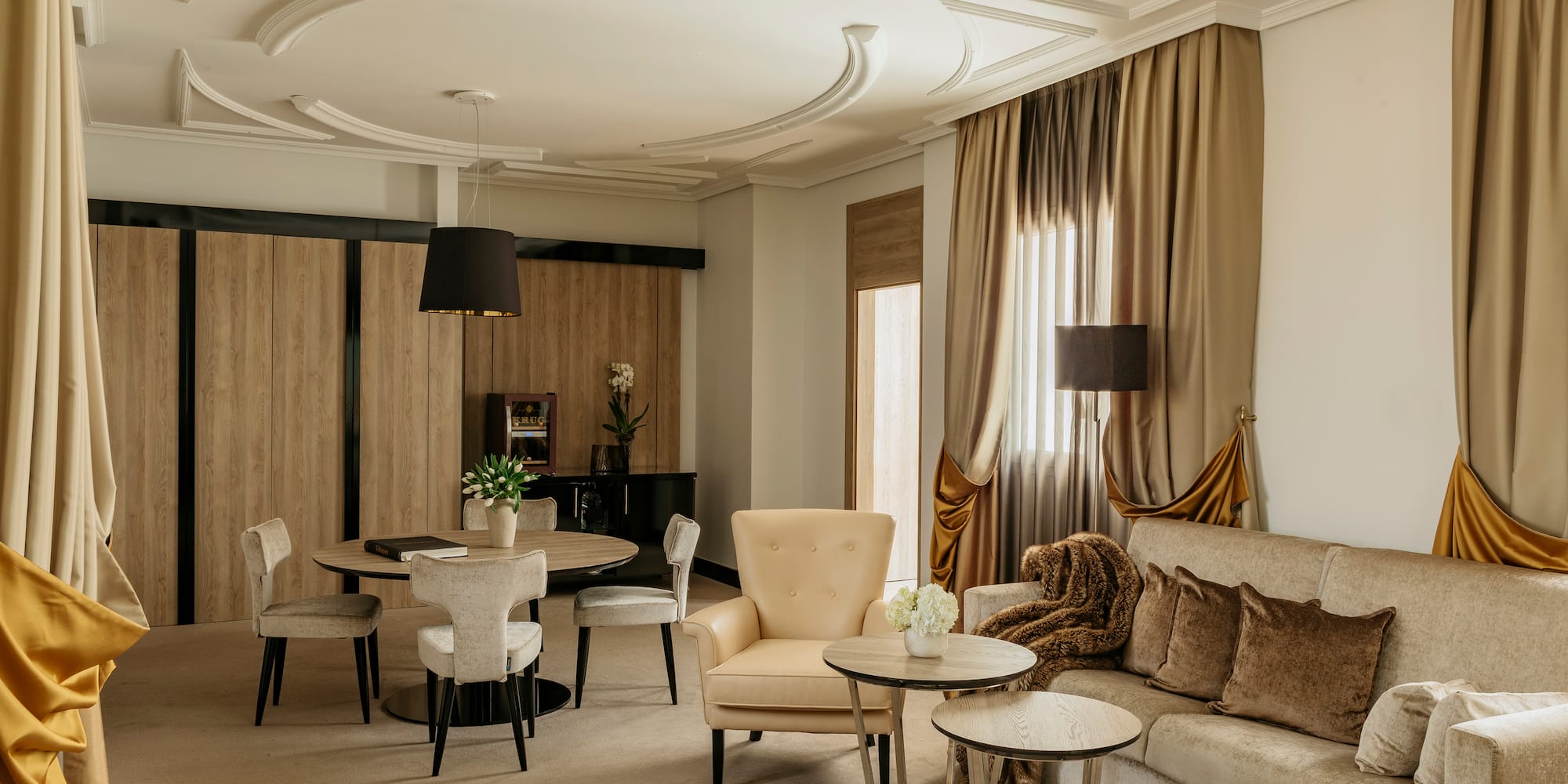 a room with a couch and chairs