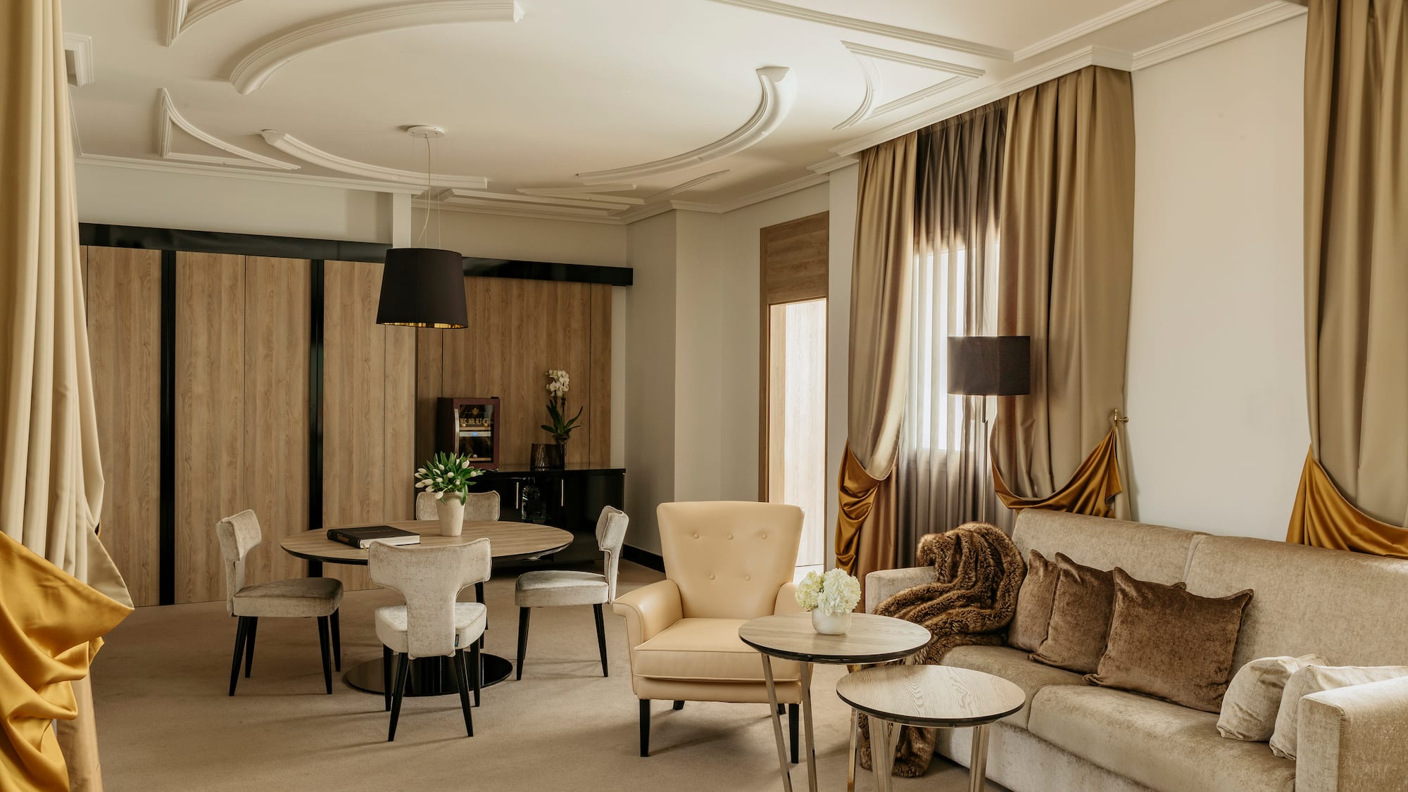 a room with a couch and chairs