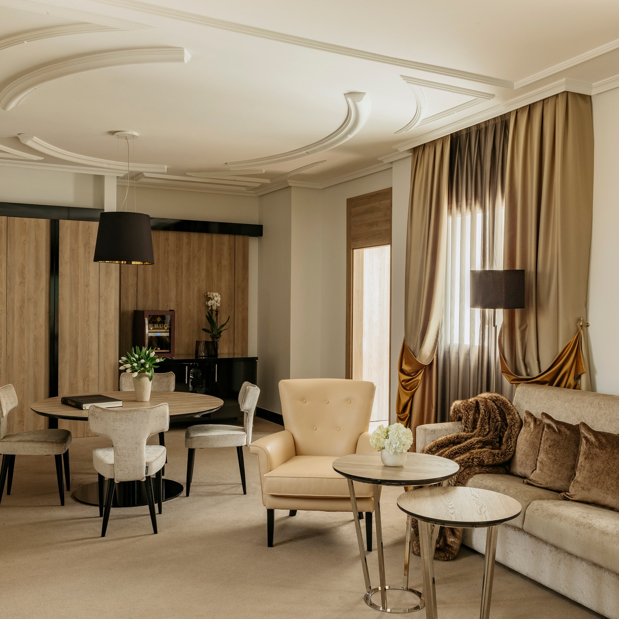 a room with a couch and chairs