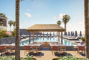 a pool with tables and chairs