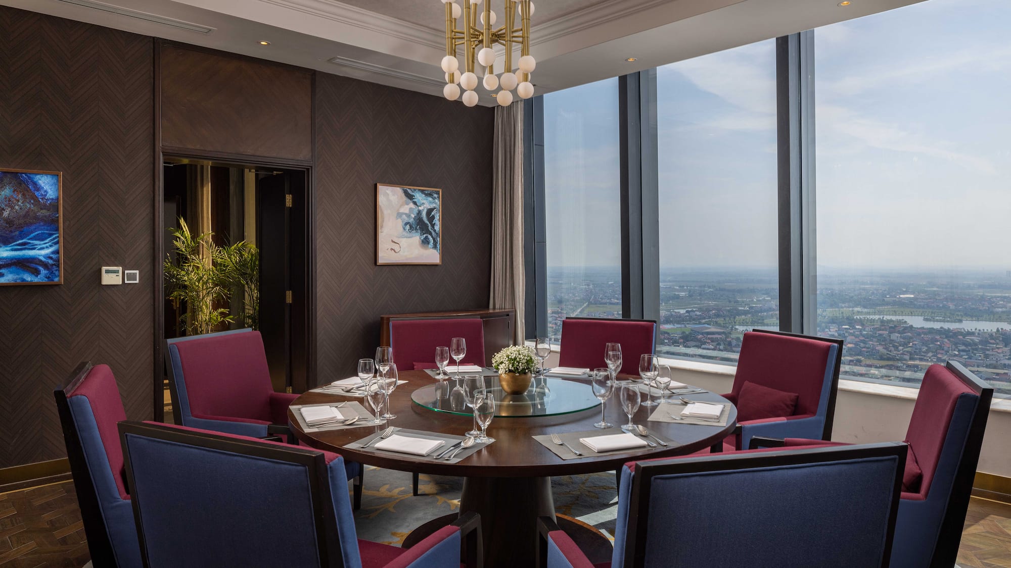 a room with a round table and chairs