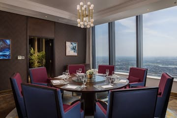 a room with a round table and chairs