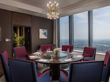a room with a round table and chairs
