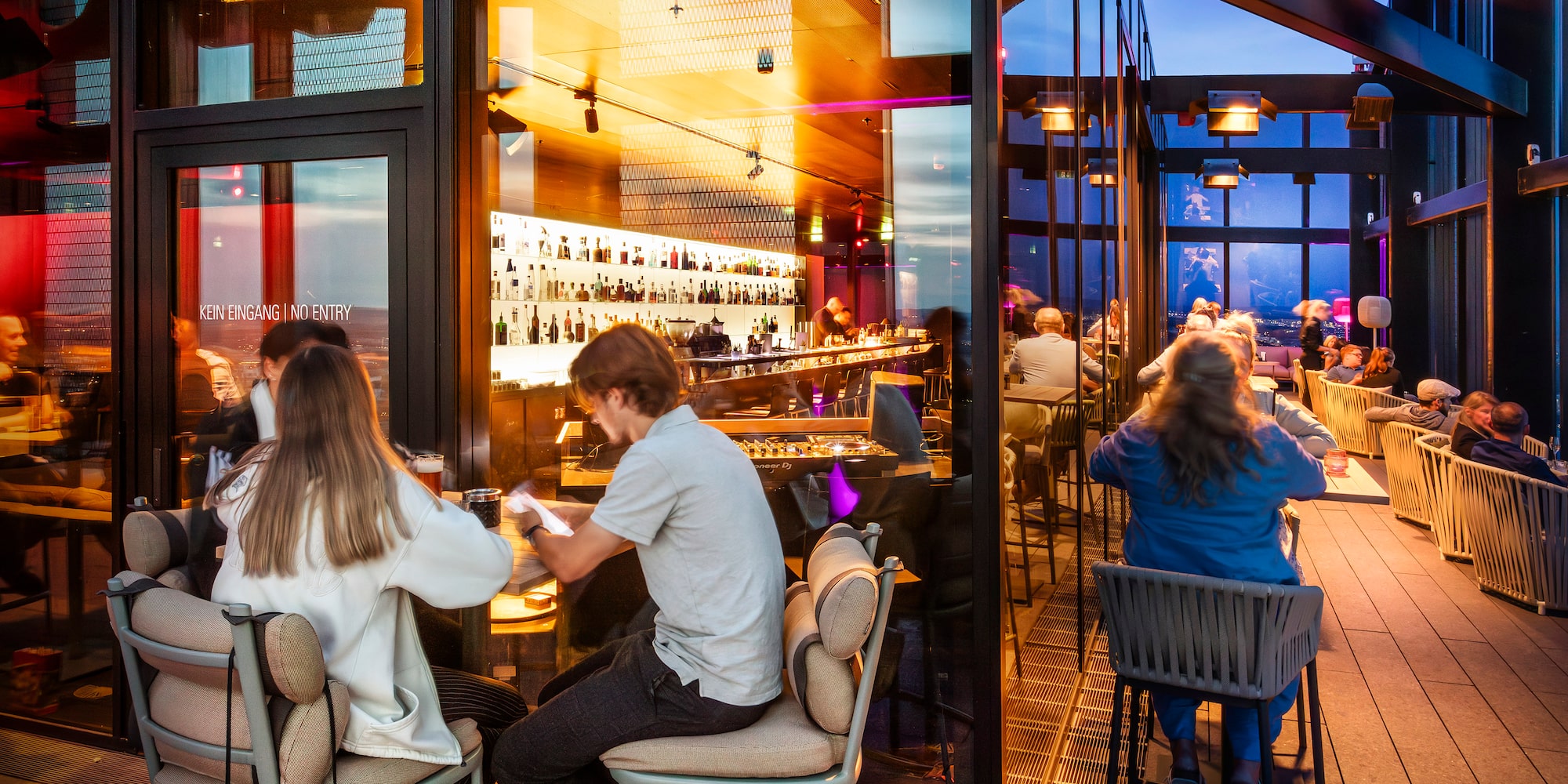 people sitting at tables in a restaurant
