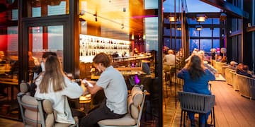 people sitting at tables in a restaurant