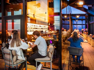 people sitting at tables in a restaurant