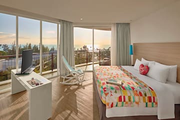 a room with a bed and a television