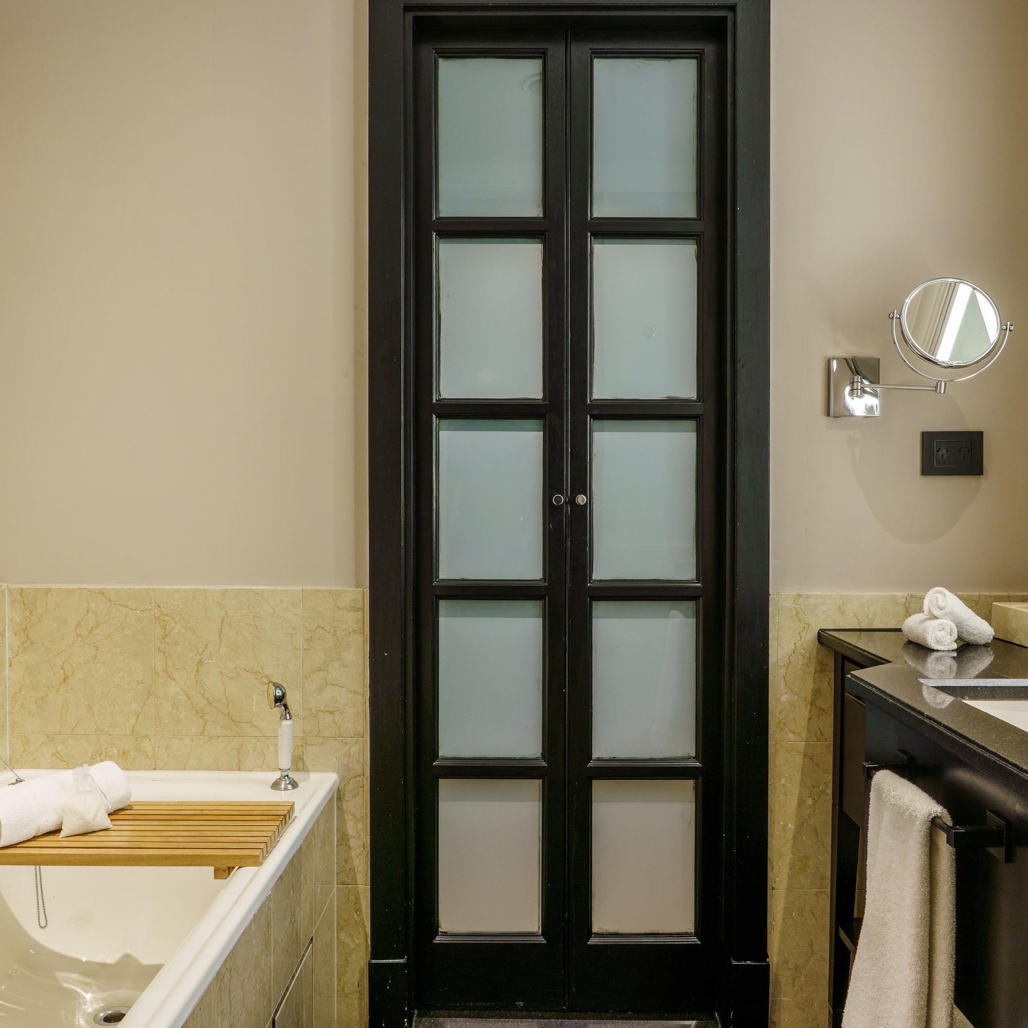 a bathroom with a tub and a door