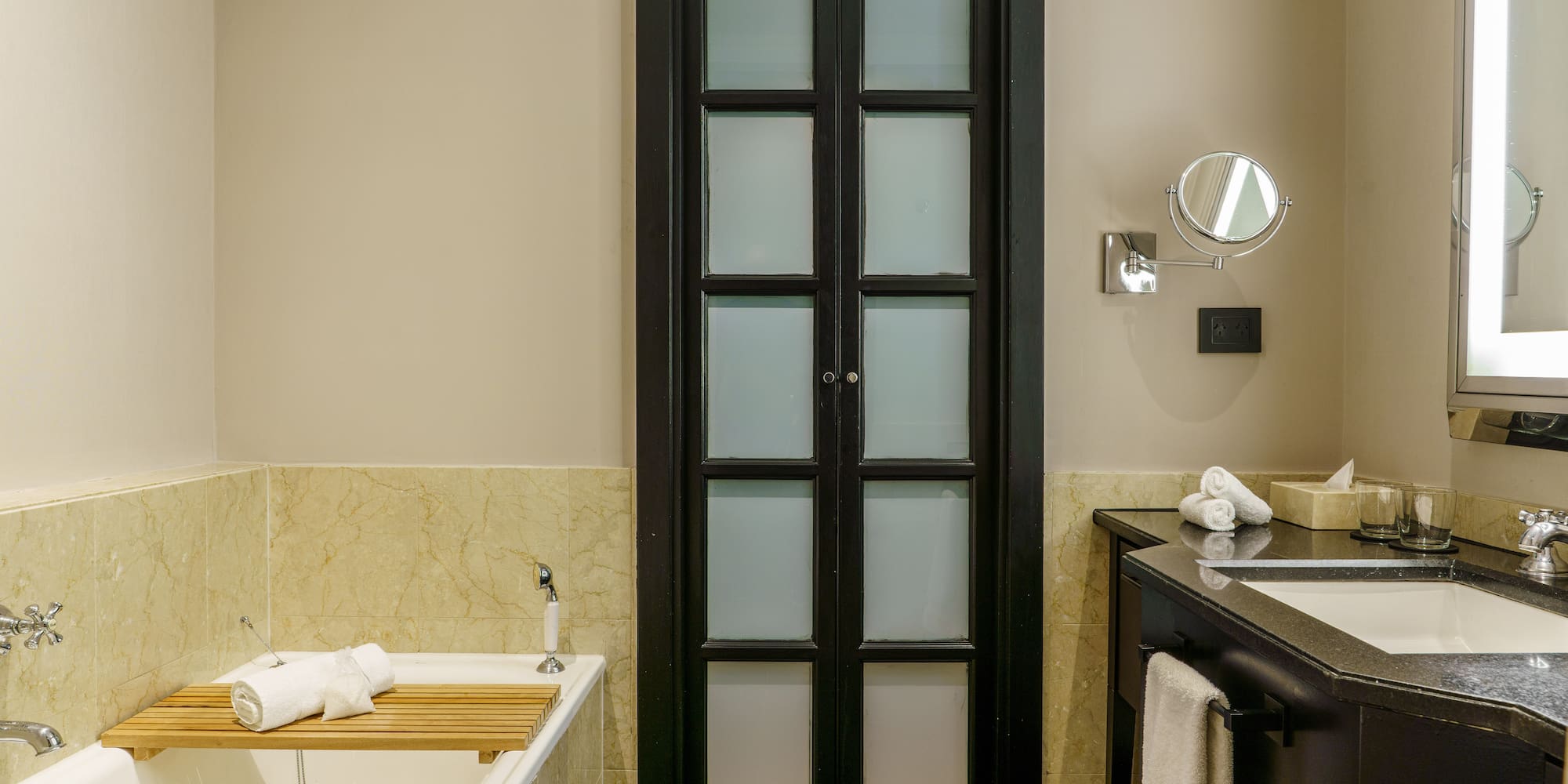 a bathroom with a tub and a door