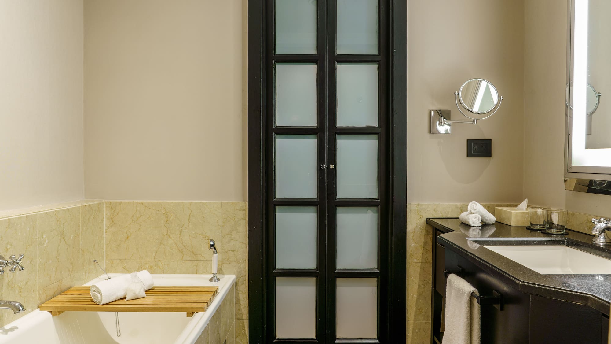 a bathroom with a tub and a door