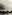 a rocky shore with a boat in the water