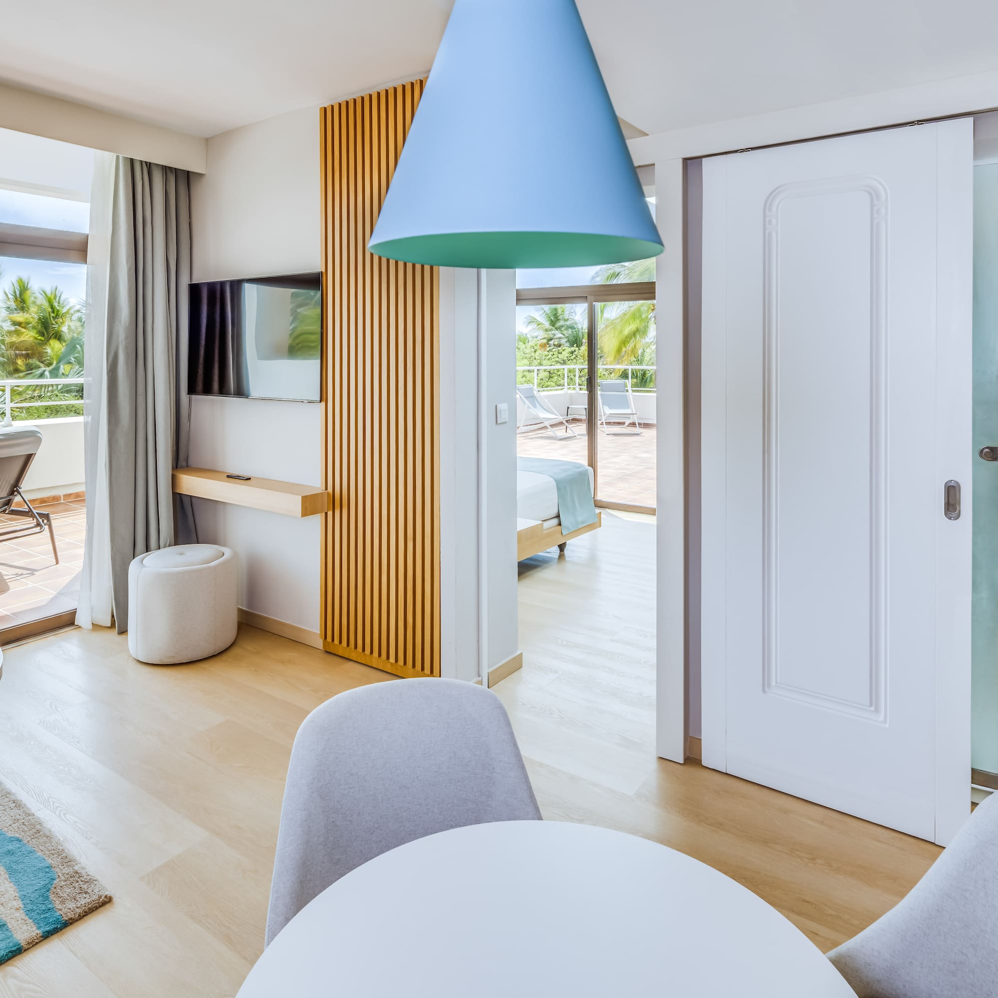 a room with a table and chairs and a television