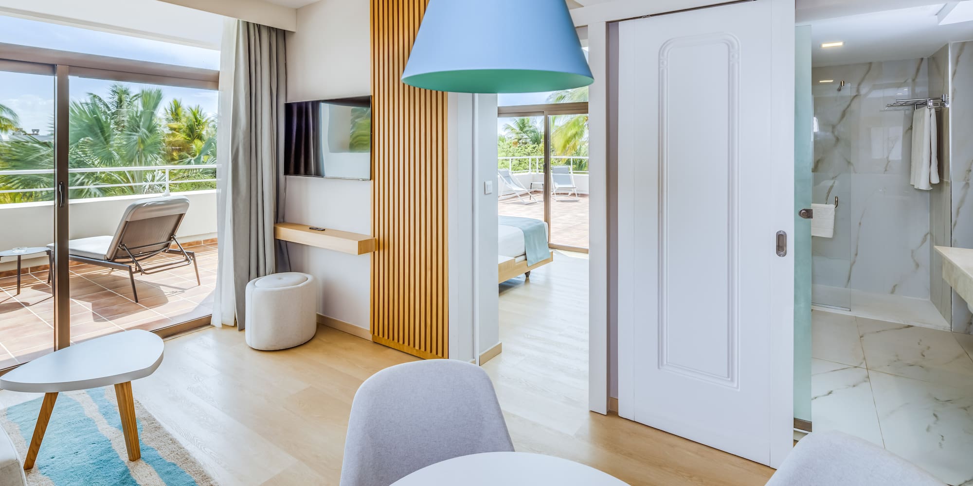 a room with a table and chairs and a television