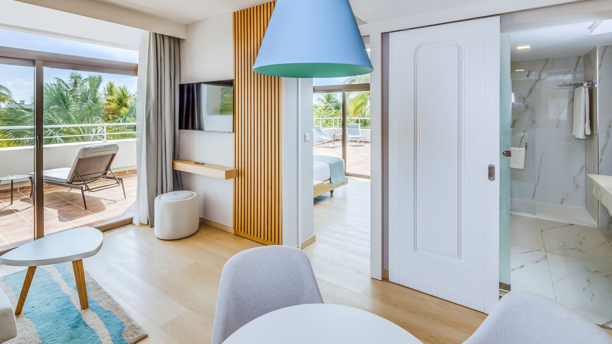 a room with a table and chairs and a television