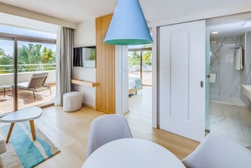 a room with a table and chairs and a television