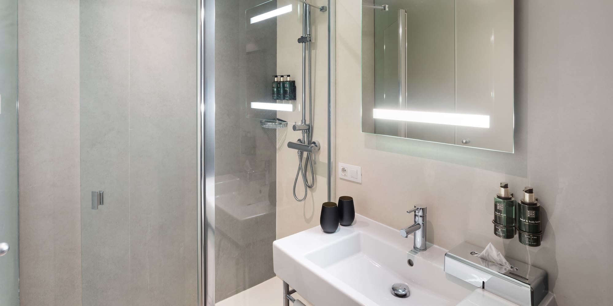 a bathroom with a shower and sink