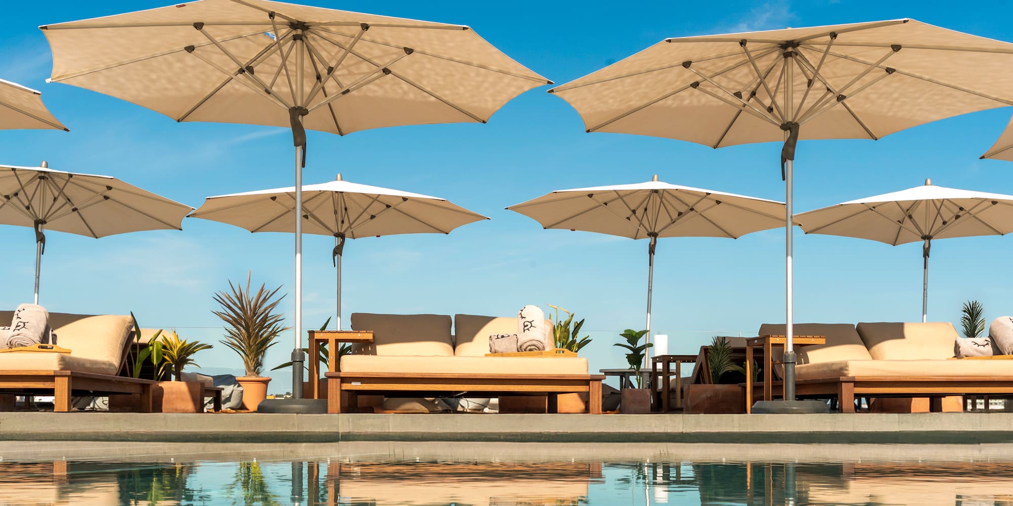 a pool with umbrellas and chairs