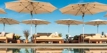 a pool with umbrellas and chairs
