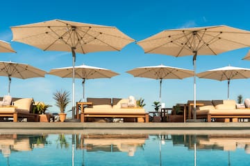 a pool with umbrellas and chairs