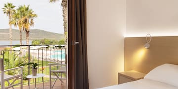 a bedroom with a door open to a pool