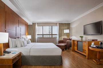 a room with a bed and a television