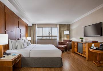 a room with a bed and a television